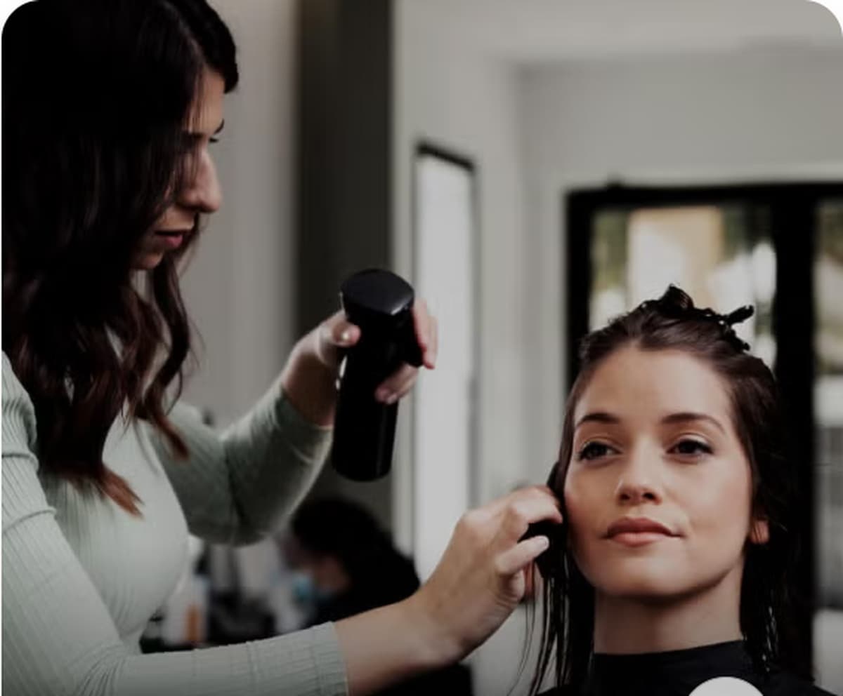 Beauty professional styling a client's hair
